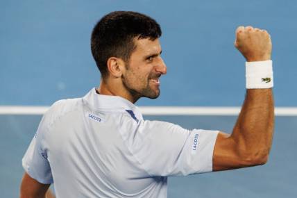 Jan 21, 2024; Melbourne, Victoria, Australia; Novak Djokovic of Serbia celebrates his victory over Adrian Mannarino of France in the forth round of the men s singles at the Australian Open 2024. Mandatory Credit: Mike Frey-USA TODAY Sports