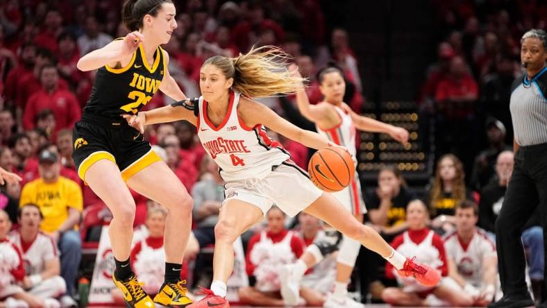 Jan 21, 2024; Columbus, Ohio, USA; Ohio State Buckeyes guard Jacy Sheldon (4) dribbles past Iowa Hawkeyes guard Caitlin Clark (22) during the NCAA women   s basketball game at Value City Arena.