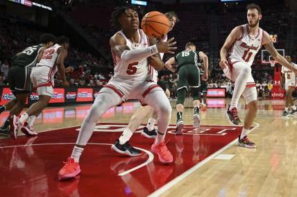 Jan 21, 2024; College Park, Maryland, USA;  Maryland Terrapins guard DeShawn Harris-Smith (5) reaches for a loose ball during the first half against the Michigan State Spartans at Xfinity Center. Mandatory Credit: Tommy Gilligan-USA TODAY Sports