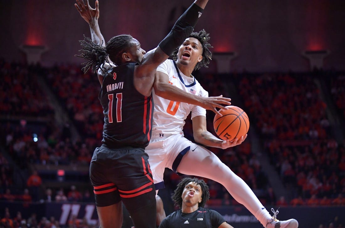 Jan 21, 2024; Champaign, Illinois, USA; Illinois Fighting Illini guard Terrence Shannon Jr. (0) drives to the basket as Rutgers Scarlet Knights center Clifford Omoruyi (11) defends during the first half at State Farm Center. Mandatory Credit: Ron Johnson-USA TODAY Sports