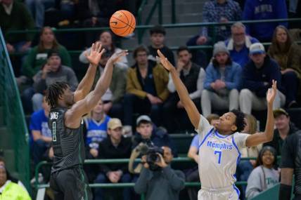 Jan 21, 2024; New Orleans, Louisiana, USA; Tulane Green Wave guard Sion James (1) shoots over Memphis Tigers forward Nae'Qwan Tomlin (7) during the first half at Avron B. Fogelman Arena in Devlin Fieldhouse. Mandatory Credit: Matthew Hinton-USA TODAY Sports