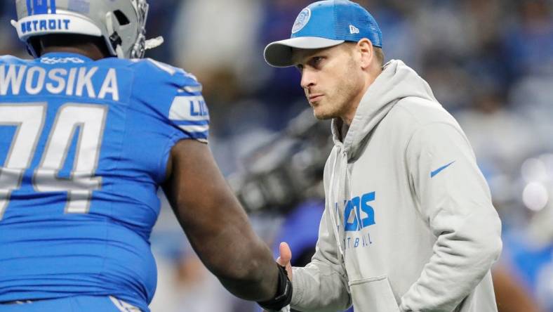 Lions offensive coordinator Ben Johnson shakes hands with guard Kayode Awosika during warmups before the NFC divisional playoff game between the Lions and Buccaneers at Ford Field on Sunday, Jan, 21, 2024.