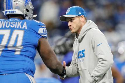 Lions offensive coordinator Ben Johnson shakes hands with guard Kayode Awosika during warmups before the NFC divisional playoff game between the Lions and Buccaneers at Ford Field on Sunday, Jan, 21, 2024.