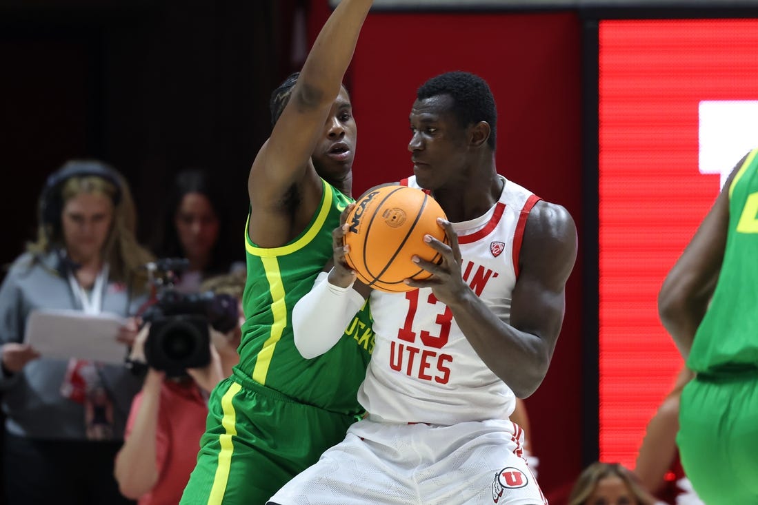 Jan 21, 2024; Salt Lake City, Utah, USA; Utah Utes center Keba Keita (13) posts up against Oregon Ducks forward Mookie Cook (11) during the first half at Jon M. Huntsman Center. Mandatory Credit: Rob Gray-USA TODAY Sports