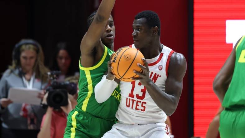 Jan 21, 2024; Salt Lake City, Utah, USA; Utah Utes center Keba Keita (13) posts up against Oregon Ducks forward Mookie Cook (11) during the first half at Jon M. Huntsman Center. Mandatory Credit: Rob Gray-USA TODAY Sports