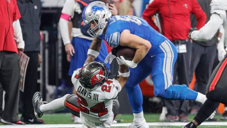 Detroit Lions tight end Sam LaPorta (87) runs against Tampa Bay Buccaneers cornerback Carlton Davis III (24) during the first half of the NFC divisional round at Ford Field in Detroit on Sunday, Jan. 21, 2024.