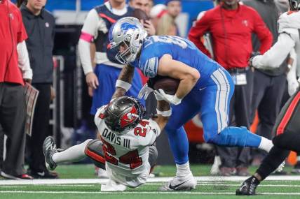 Detroit Lions tight end Sam LaPorta (87) runs against Tampa Bay Buccaneers cornerback Carlton Davis III (24) during the first half of the NFC divisional round at Ford Field in Detroit on Sunday, Jan. 21, 2024.