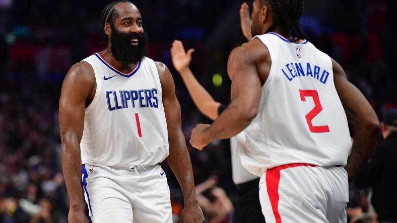 Jan 21, 2024; Los Angeles, California, USA; Los Angeles Clippers guard James Harden (1) reacts after forward Kawhi Leonard (2) scores three point basket against the Brooklyn Nets during the second half at Crypto.com Arena. Mandatory Credit: Gary A. Vasquez-USA TODAY Sports