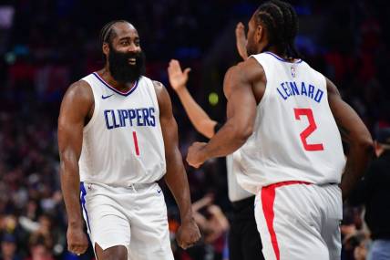 Jan 21, 2024; Los Angeles, California, USA; Los Angeles Clippers guard James Harden (1) reacts after forward Kawhi Leonard (2) scores three point basket against the Brooklyn Nets during the second half at Crypto.com Arena. Mandatory Credit: Gary A. Vasquez-USA TODAY Sports