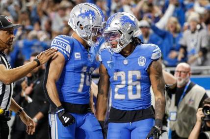 Detroit Lions running back Jahmyr Gibbs (26) celebrates a touchdown against Tampa Bay Buccaneers with wide receiver Amon-Ra St. Brown (14) during the second half of the NFC divisional round at Ford Field in Detroit on Sunday, Jan. 21, 2024.