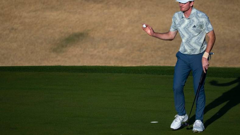 Nick Dunlap gestures to the gallery after putting for a birdie on the 16th green on the Pete Dye Stadium Course during the final round of The American Express at PGA West in La Quinta, Calif., Sunday, Jan. 21, 2024.