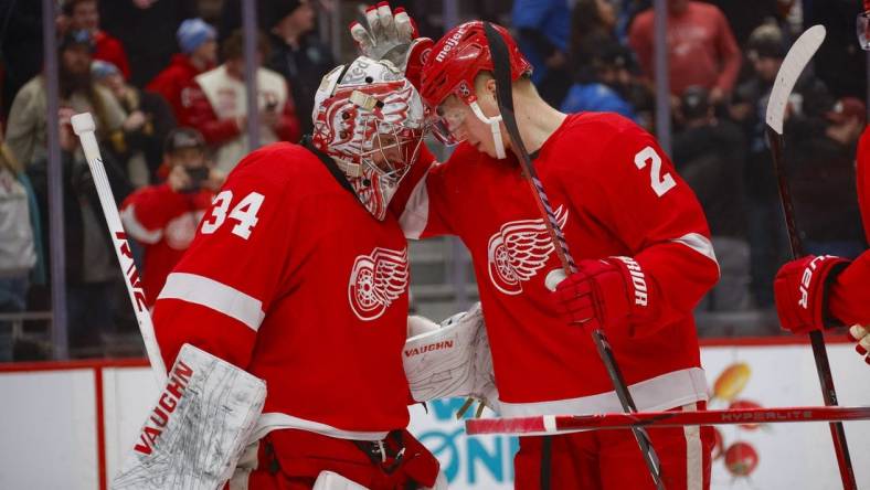 Jan 21, 2024; Detroit, Michigan, USA; Detroit Red Wings goaltender Alex Lyon (34) is congratulated by Detroit Red Wings defenseman Olli Maatta (2) at the end of the game against the Tampa Bay Lightning at Little Caesars Arena. Mandatory Credit: Brian Bradshaw Sevald-USA TODAY Sports