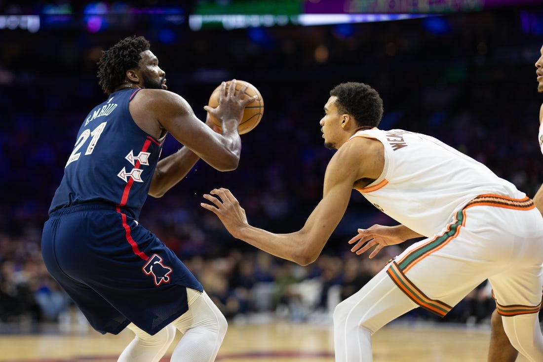 Jan 22, 2024; Philadelphia, Pennsylvania, USA; Philadelphia 76ers center Joel Embiid (21) shoots against San Antonio Spurs center Victor Wembanyama (1) during the second quarter at Wells Fargo Center. Mandatory Credit: Bill Streicher-USA TODAY Sports