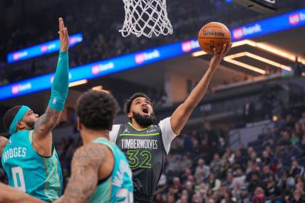Jan 22, 2024; Minneapolis, Minnesota, USA; Minnesota Timberwolves center Karl-Anthony Towns (32) shoots against the Charlotte Hornets in the first quarter at Target Center. Mandatory Credit: Brad Rempel-USA TODAY Sports