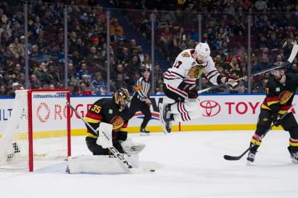 Jan 22, 2024; Vancouver, British Columbia, CAN; Vancouver Canucks defenseman Filip Hronek (17) watches as goalie Thatcher Demko (35) makes a save behind leaping Chicago Blackhawks forward Nick Foligno (17) in the second period at Rogers Arena. Mandatory Credit: Bob Frid-USA TODAY Sports