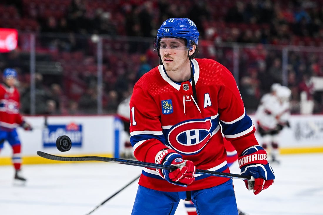 Jan 23, 2024; Montreal, Quebec, CAN; Montreal Canadiens right wing Brendan Gallagher (11) plays with a puck during a warm-up before the game against the Ottawa Senators at Bell Centre. Mandatory Credit: David Kirouac-USA TODAY Sports