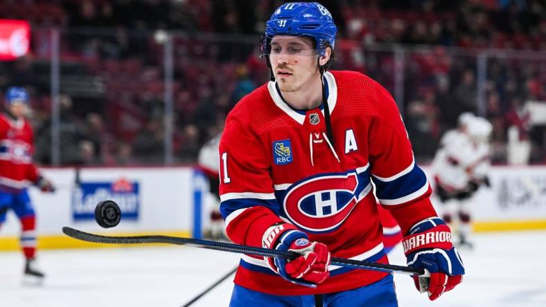 Jan 23, 2024; Montreal, Quebec, CAN; Montreal Canadiens right wing Brendan Gallagher (11) plays with a puck during a warm-up before the game against the Ottawa Senators at Bell Centre. Mandatory Credit: David Kirouac-USA TODAY Sports