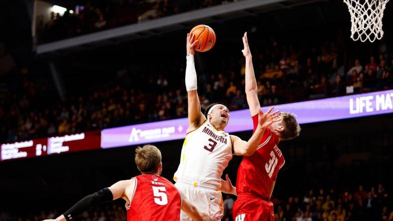 Jan 23, 2024; Minneapolis, Minnesota, USA; Minnesota Golden Gophers forward Dawson Garcia (3) shoots as Wisconsin Badgers forward Nolan Winter (31) defends during the first half at Williams Arena. Mandatory Credit: Matt Krohn-USA TODAY Sports