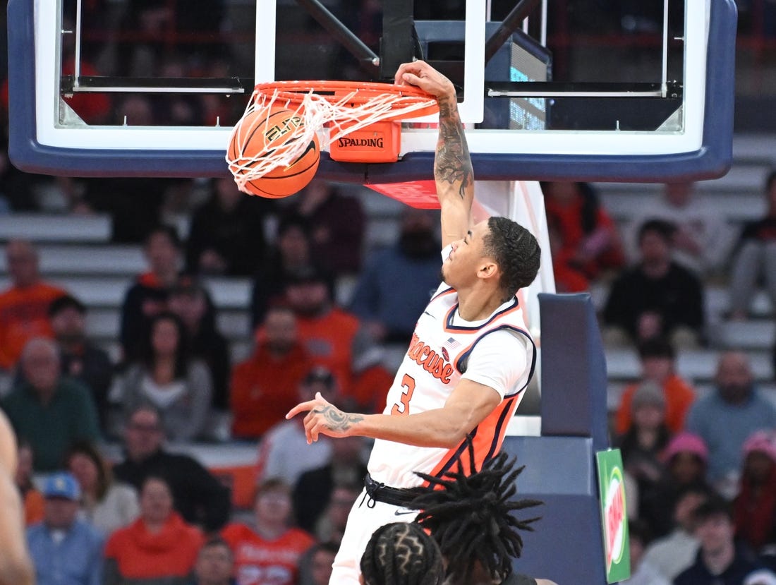 Jan 23, 2024; Syracuse, New York, USA; Syracuse Orange forward Benny Williams (13) dunks the ball against the Florida State Seminoles in the first half at the JMA Wireless Dome. Mandatory Credit: Mark Konezny-USA TODAY Sports