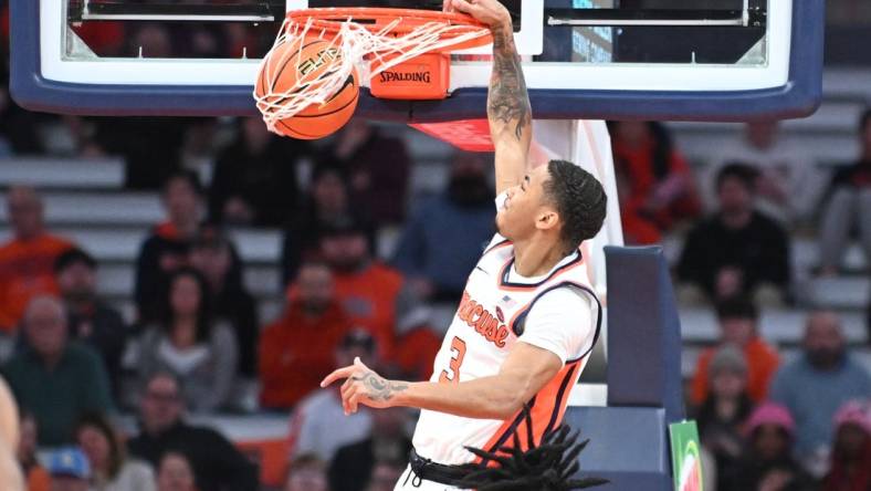 Jan 23, 2024; Syracuse, New York, USA; Syracuse Orange forward Benny Williams (13) dunks the ball against the Florida State Seminoles in the first half at the JMA Wireless Dome. Mandatory Credit: Mark Konezny-USA TODAY Sports