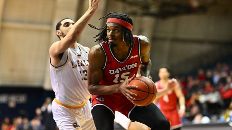 Jan 23, 2024; Philadelphia, Pennsylvania, USA; Dayton Flyers forward DaRon Holmes II (15) controls the ball against La Salle Explorers guard Daeshon Shepherd (13) in the first half at Tom Gola Arena at TruMark Financial Center. Mandatory Credit: Kyle Ross-USA TODAY Sports