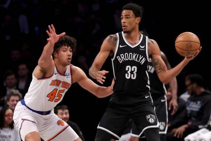 Jan 23, 2024; Brooklyn, New York, USA; Brooklyn Nets center Nic Claxton (33) looks to pass the ball against New York Knicks center Jericho Sims (45) during the first quarter at Barclays Center. Mandatory Credit: Brad Penner-USA TODAY Sports