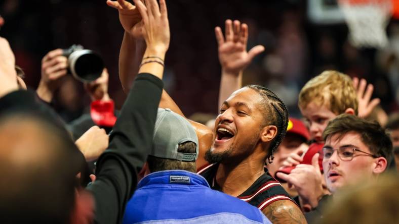 Jan 23, 2024; Columbia, South Carolina, USA; South Carolina Gamecocks guard Ta'Lon Cooper (55) celebrates with students after beating the Kentucky Wildcats at Colonial Life Arena. Mandatory Credit: Jeff Blake-USA TODAY Sports