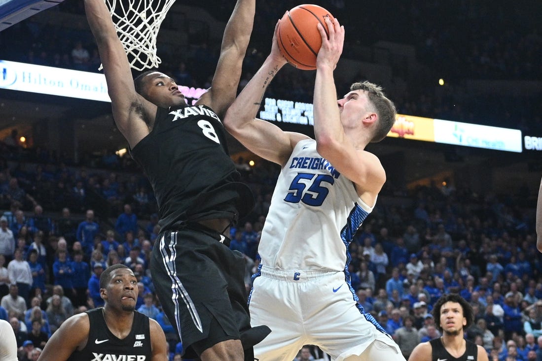 Jan 23, 2024; Omaha, Nebraska, USA;  Creighton Bluejays guard Baylor Scheierman (55) attempts a shot against Xavier Musketeers guard Quincy Olivari (8) in the second half at CHI Health Center Omaha. Mandatory Credit: Steven Branscombe-USA TODAY Sports