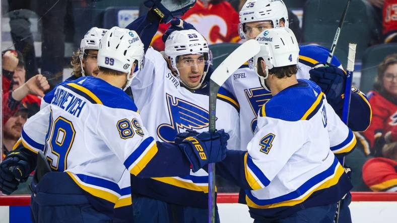 Jan 23, 2024; Calgary, Alberta, CAN; St. Louis Blues center Jordan Kyrou (25) celebrates his goal with teammates against the Calgary Flames during the third period at Scotiabank Saddledome. Mandatory Credit: Sergei Belski-USA TODAY Sports