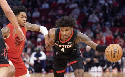 Jan 24, 2024; Houston, Texas, USA; Houston Rockets guard Jalen Green (4) dribbles against Portland Trail Blazers guard Anfernee Simons (1) in the first quarter at Toyota Center. Mandatory Credit: Thomas Shea-USA TODAY Sports