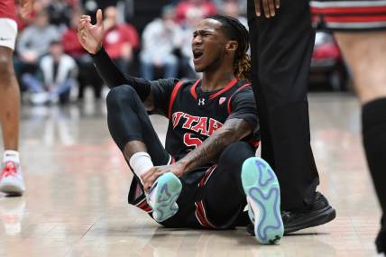 Jan 24, 2024; Pullman, Washington, USA; Utah Utes guard Deivon Smith (5) grab his ankle during a game against the Washington State Cougars in the first half at Friel Court at Beasley Coliseum. Mandatory Credit: James Snook-USA TODAY Sports