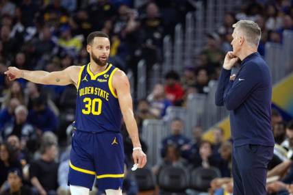 Jan 25, 2024; San Francisco, California, USA; Golden State Warriors guard Stephen Curry (30) consults with head coach Steve Kerr during the first quarter against the Sacramento Kings at Chase Center. Mandatory Credit: D. Ross Cameron-USA TODAY Sports