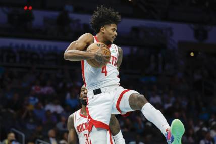 Jan 26, 2024; Charlotte, North Carolina, USA; Houston Rockets guard Jalen Green (4) pulls down a rebound against the Charlotte Hornets during the first quarter at Spectrum Center. Mandatory Credit: Nell Redmond-USA TODAY Sports