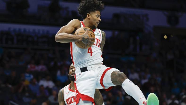 Jan 26, 2024; Charlotte, North Carolina, USA; Houston Rockets guard Jalen Green (4) pulls down a rebound against the Charlotte Hornets during the first quarter at Spectrum Center. Mandatory Credit: Nell Redmond-USA TODAY Sports