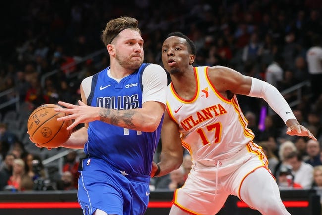 Jan 26, 2024; Atlanta, Georgia, USA; Dallas Mavericks guard Luka Doncic (77) moves past Atlanta Hawks forward Onyeka Okongwu (17) in the first quarter at State Farm Arena. Mandatory Credit: Brett Davis-USA TODAY Sports