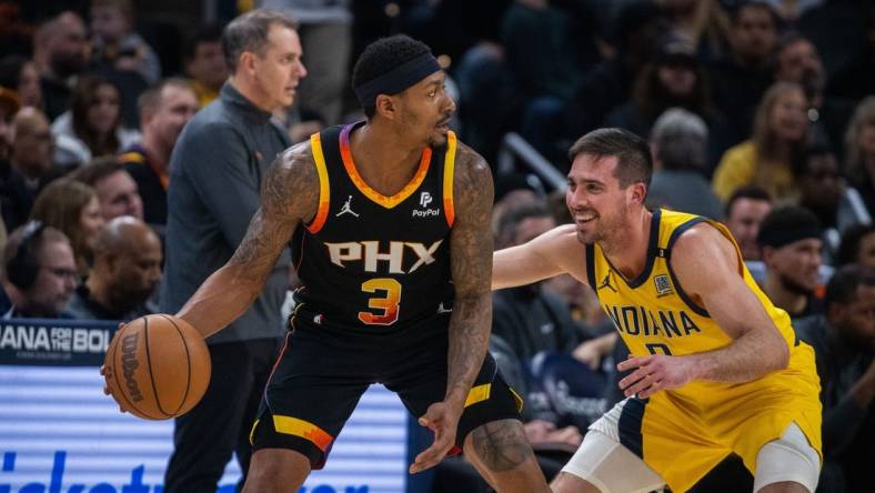 Jan 26, 2024; Indianapolis, Indiana, USA; Phoenix Suns guard Bradley Beal (3) dribbles the ball while Indiana Pacers guard T.J. McConnell (9) defends in the first half at Gainbridge Fieldhouse. Mandatory Credit: Trevor Ruszkowski-USA TODAY Sports