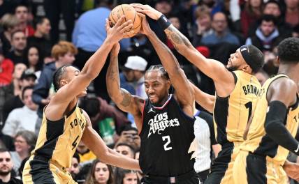 Jan 26, 2024; Toronto, Ontario, CAN;   Los Angeles Clippers forward Kawhi Leonard (2) battles for the ball against Toronto Raptors forward Scottie Barnes (4) and guard Bruce Brown (11) in the first half at Scotiabank Arena. Mandatory Credit: Dan Hamilton-USA TODAY Sports