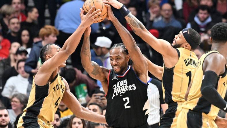 Jan 26, 2024; Toronto, Ontario, CAN;   Los Angeles Clippers forward Kawhi Leonard (2) battles for the ball against Toronto Raptors forward Scottie Barnes (4) and guard Bruce Brown (11) in the first half at Scotiabank Arena. Mandatory Credit: Dan Hamilton-USA TODAY Sports