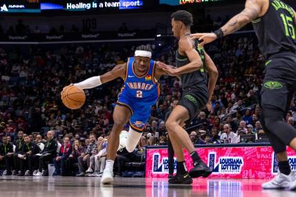 Jan 26, 2024; New Orleans, Louisiana, USA; Oklahoma City Thunder guard Shai Gilgeous-Alexander (2) dribbles against New Orleans Pelicans guard Trey Murphy III (25) during the first half at Smoothie King Center. Mandatory Credit: Stephen Lew-USA TODAY Sports