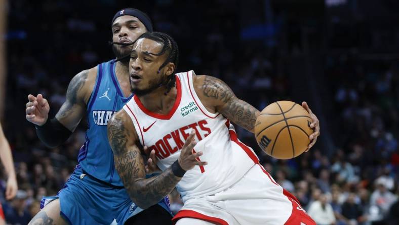 Jan 26, 2024; Charlotte, North Carolina, USA; Houston Rockets forward Cam Whitmore (7) moves against Charlotte Hornets forward Miles Bridges (0) during the second half at Spectrum Center. Mandatory Credit: Nell Redmond-USA TODAY Sports