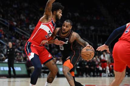 Jan 27, 2024; Detroit, Michigan, USA; Detroit Pistons guard Monte Morris (5) drives to the basket against Washington Wizards forward Marvin Bagley III (35) in the first quarter at Little Caesars Arena. Mandatory Credit: Lon Horwedel-USA TODAY Sports