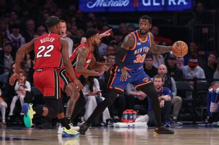 Jan 27, 2024; New York, New York, USA; New York Knicks forward Julius Randle (30) controls the ball as Miami Heat forward Haywood Highsmith (24) and forward Jimmy Butler (22) defend during the first half at Madison Square Garden. Mandatory Credit: Vincent Carchietta-USA TODAY Sports