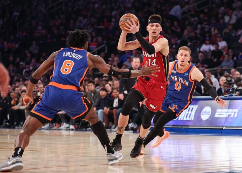 Jan 27, 2024; New York, New York, USA; Miami Heat guard Tyler Herro (14) drives to the basket after the game New York Knicks forward OG Anunoby (8) and guard Donte DiVincenzo (0) during the first half at Madison Square Garden. Mandatory Credit: Vincent Carchietta-USA TODAY Sports