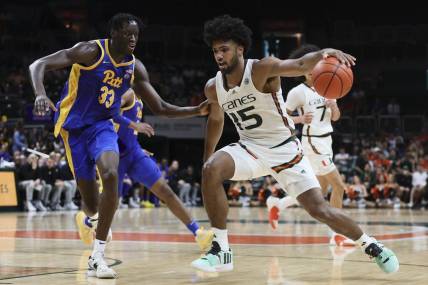Jan 27, 2024; Coral Gables, Florida, USA; Miami Hurricanes forward Norchad Omier (15) drives to the basket against Pittsburgh Panthers center Federiko Federiko (33) during the second half at Watsco Center. Mandatory Credit: Sam Navarro-USA TODAY Sports