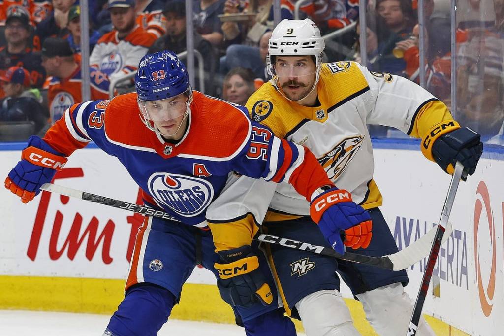 Jan 27, 2024; Edmonton, Alberta, CAN; Edmonton Oilers forward Ryan Nugent-Hopkins (93) and Nashville Predators forward Filip Forsberg (9) battle for position during the second period at Rogers Place. Mandatory Credit: Perry Nelson-USA TODAY Sports