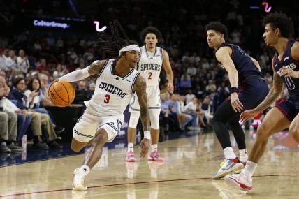 Jan 27, 2024; Richmond, Virginia, USA; Richmond Spiders guard DeLonnie Hunt (3) dribbles teh ball as Dayton Flyers guard Javon Bennett (0) defends during the first half at the Robins Center. Mandatory Credit: Amber Searls-USA TODAY Sports