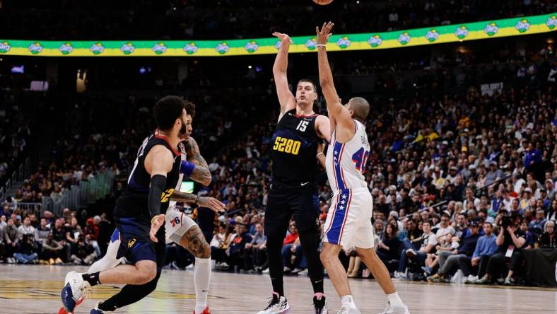 Jan 27, 2024; Denver, Colorado, USA; Denver Nuggets center Nikola Jokic (15) looks to pass the ball to guard Jamal Murray (27) as Philadelphia 76ers forward Nicolas Batum (40) and guard Kelly Oubre Jr. (9) defend in the second quarter at Ball Arena. Mandatory Credit: Isaiah J. Downing-USA TODAY Sports