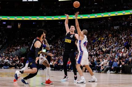 Jan 27, 2024; Denver, Colorado, USA; Denver Nuggets center Nikola Jokic (15) looks to pass the ball to guard Jamal Murray (27) as Philadelphia 76ers forward Nicolas Batum (40) and guard Kelly Oubre Jr. (9) defend in the second quarter at Ball Arena. Mandatory Credit: Isaiah J. Downing-USA TODAY Sports