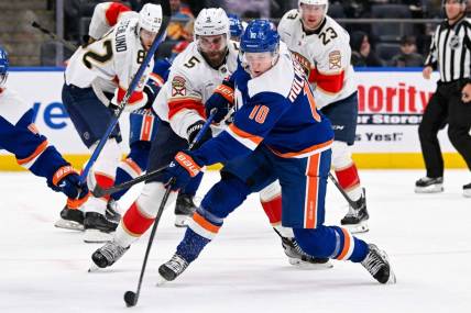 Jan 27, 2024; Elmont, New York, USA; New York Islanders right wing Simon Holmstrom (10) shoots and scores a goal against the Florida Panthers during the second period at UBS Arena. Mandatory Credit: Dennis Schneidler-USA TODAY Sports