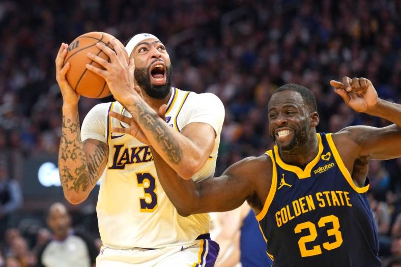 Jan 27, 2024; San Francisco, California, USA; Los Angeles Lakers forward Anthony Davis (3) shoots while being fouled by Golden State Warriors forward Draymond Green (23) during the second quarter at Chase Center. Mandatory Credit: Darren Yamashita-USA TODAY Sports